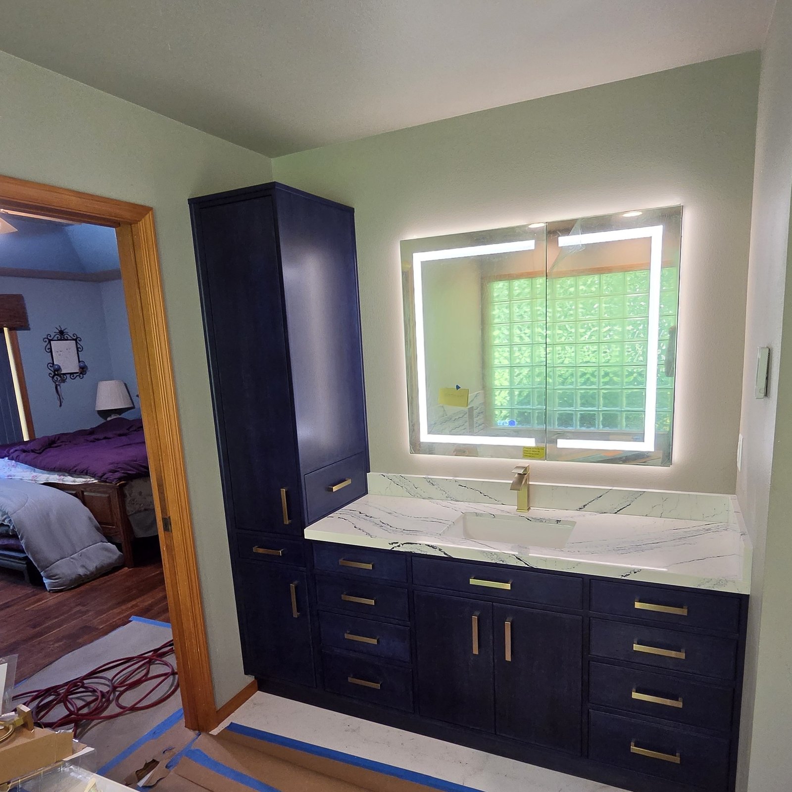 Casey Jay Winters Construction custom blue dye on cherry bathroom vanity with marble countertop and LED mirror, Tillamook Oregon