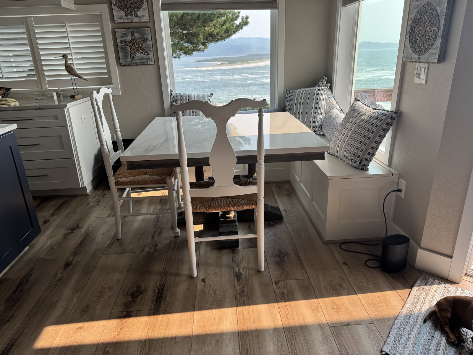 Built-in storage bench nook with dining table and Oregon Coast view