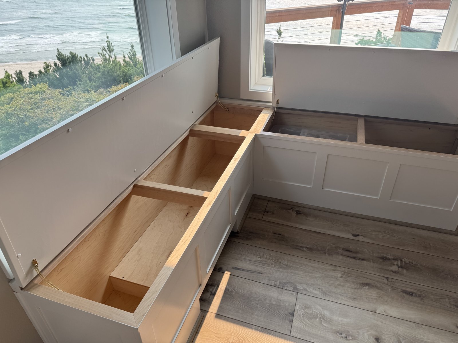 Built-in bench storage compartments with hinged lids open