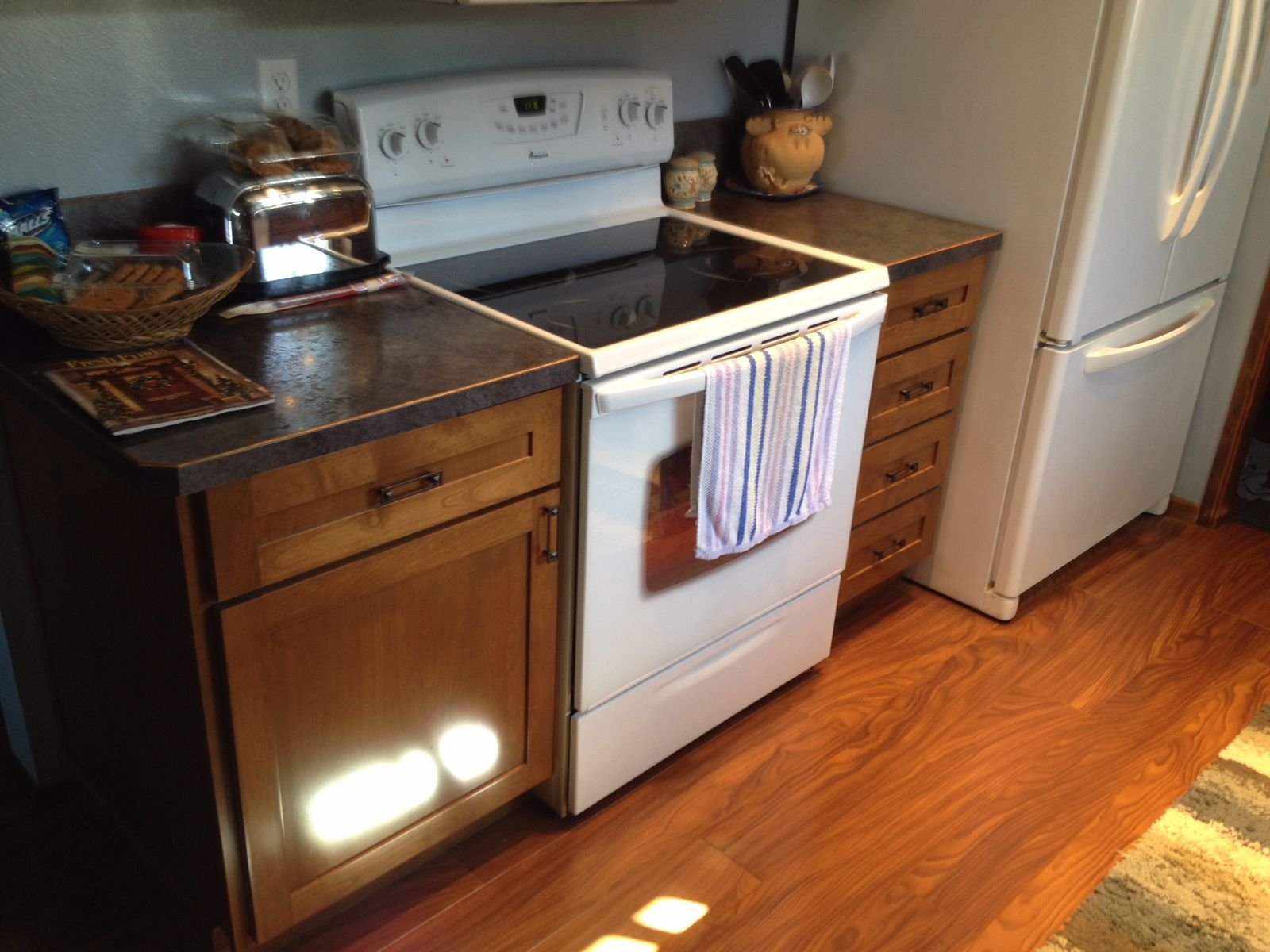 Kitchen cabinet installation with custom stain finish