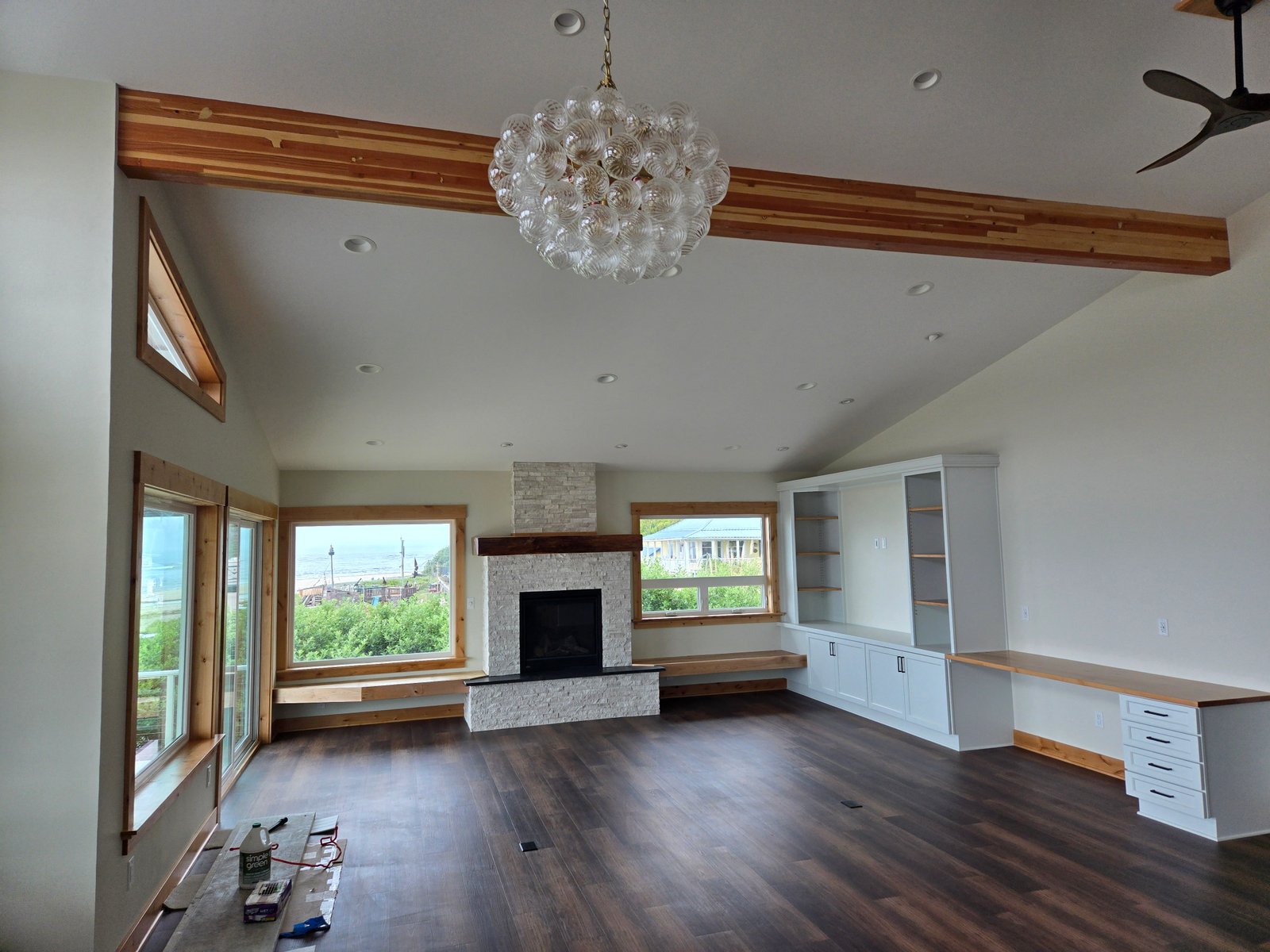 Finished living room with custom built-ins and ocean view