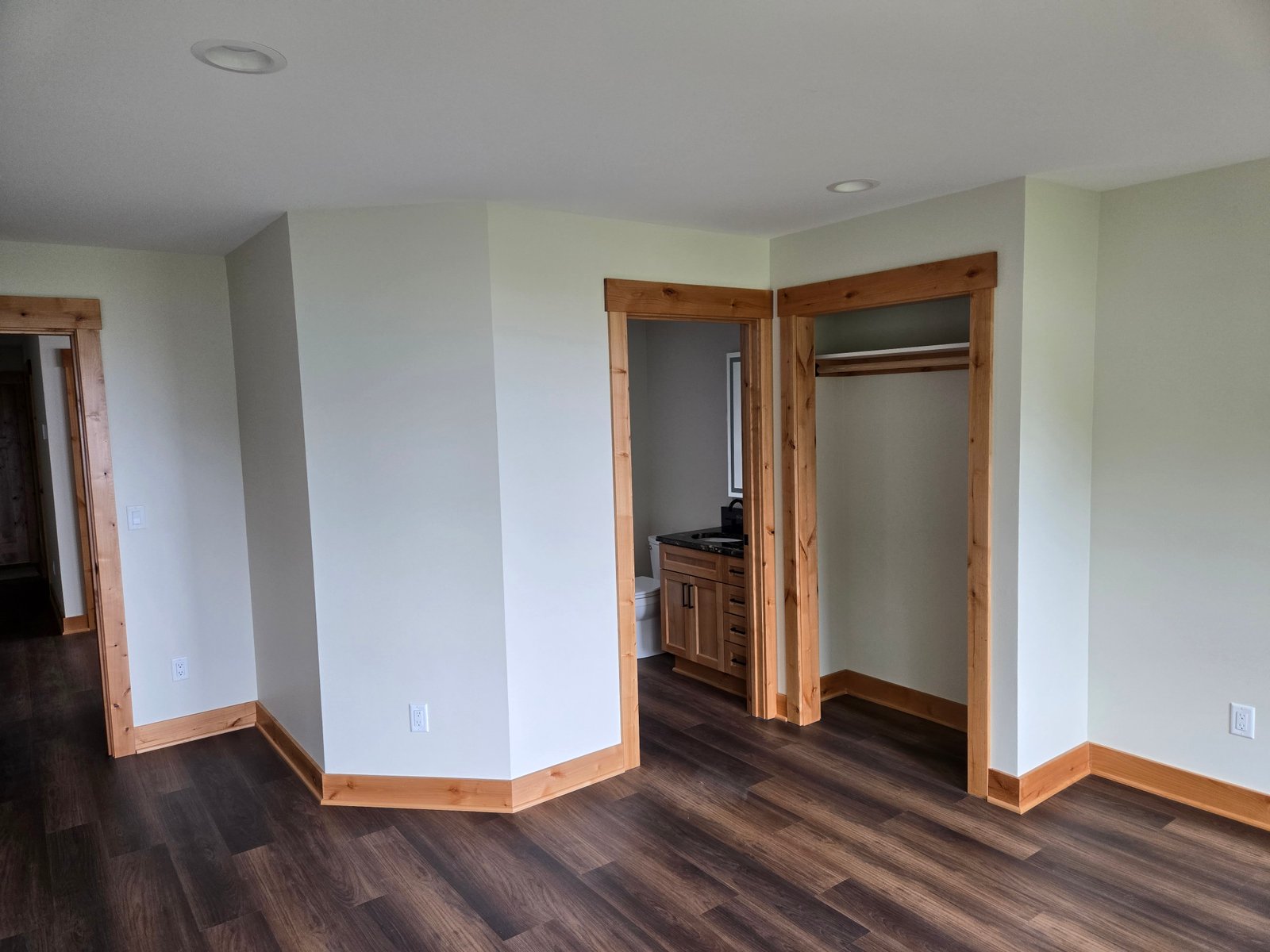 Finished bedroom with custom alder trim and built-ins