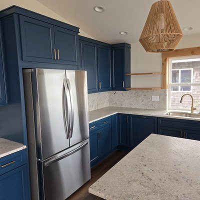 Casey Jay Winters Construction custom blue kitchen cabinetry with gold hardware and granite countertops, Tillamook Oregon