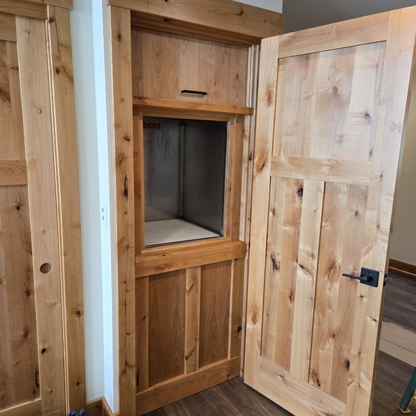 Casey Jay Winters Construction custom alder interior doors with panel detailing and black hardware, Tillamook Oregon
